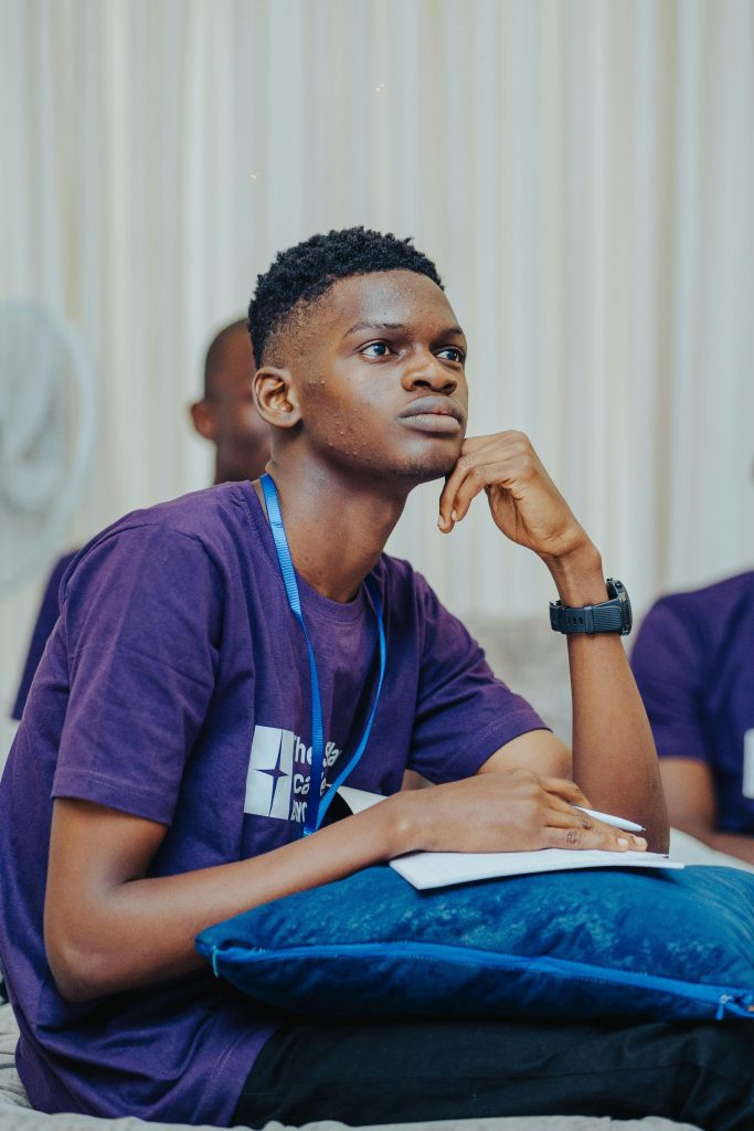Focused young man in Lagos, Nigeria, attentively participating in an educational lecture.